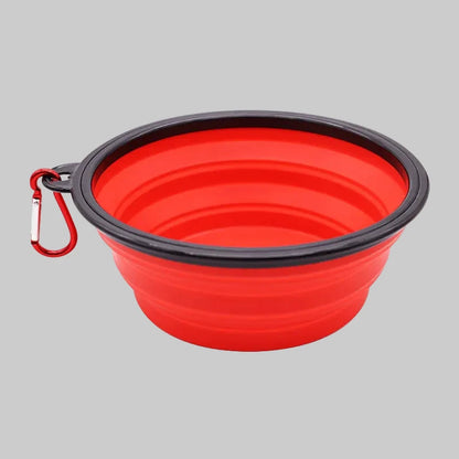 Red collapsible dog bowl with black rim and carabiner